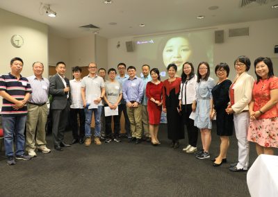 QUT members and friends singing  at the party