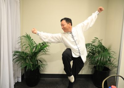 A/Professor Longbin Huang performing Tai Chi at the party